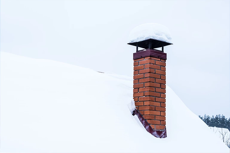 Stainless chimney cap installed on a masonry chimney