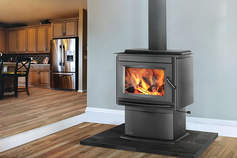 What is the difference between wood stove coverage and efficiency