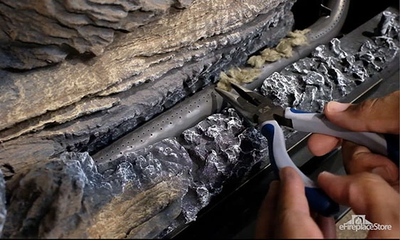 Proper ember wool placement over burner ports