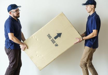 Two men delivering a fireplace insert shipment