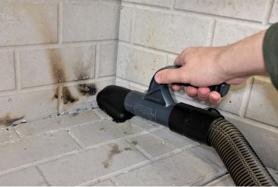 Vacuuming the firebox with a brush hose