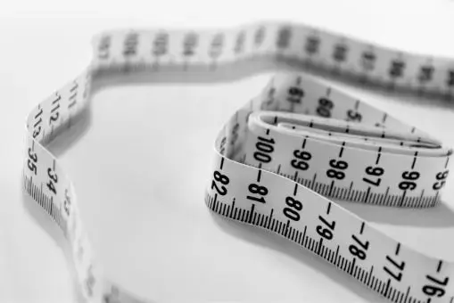 White measuring tape used to record fireplace dimensions